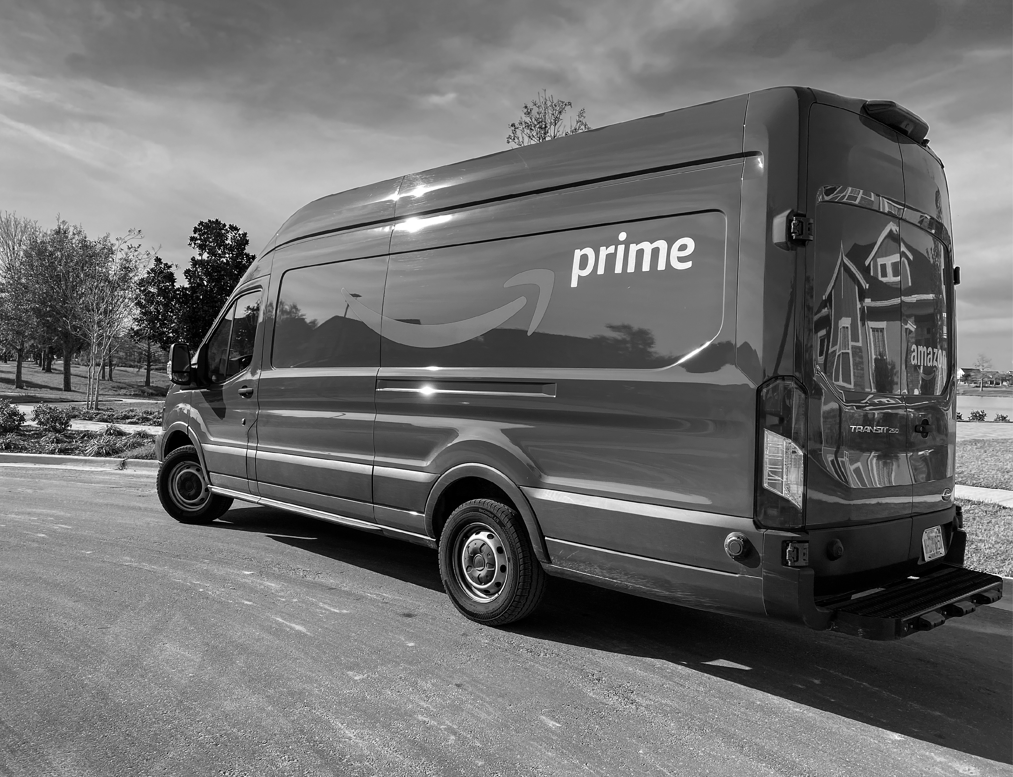 An image of an Amazon delivery truck parked at the end of a cul-de-sac.